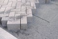 Gray paving blocks on the ballast, side view, construction site of pavement modern granite cobblestone road in city center, Royalty Free Stock Photo