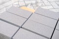 Gray paving blocks on the ballast, side view, construction site of pavement modern granite cobblestone road in city center, Royalty Free Stock Photo