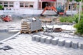 gray paving blocks on the ballast, side view, construction site of pavement modern granite cobblestone road in city center,