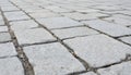 Gray paving stone texture shows a close-up of rough, weathered blocks. Interlocking slabs create a gritty surface for urban Royalty Free Stock Photo