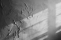 Gray plaster wall with shadows from sunlight. Abstract background for presentations
