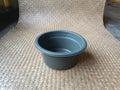 Gray plastic basin on a woven pandan leaf mat Royalty Free Stock Photo