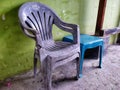 gray plastic chairs and green plastic tables, found in the yard.