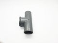 Gray plastic plumbing tee fitting for pipe connection on a white background Royalty Free Stock Photo
