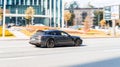 Gray Porsche Panamera Sport Turismo is driving along the street with an autumn urban background Royalty Free Stock Photo