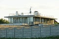 Gray private house behind a concrete fence Royalty Free Stock Photo