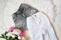 Gray ragged shorts, white jeans and peonies on white fur. Fashionable concept Royalty Free Stock Photo