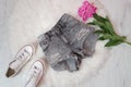 Gray ragged shorts, white sneakers and peony flower. Fashionable concept, white fur on the background Royalty Free Stock Photo