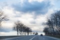 Gray rainy clouds over highway in early spring Royalty Free Stock Photo