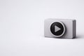Gray rectangular device with black circular play button on white background Royalty Free Stock Photo