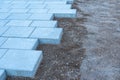 Gray rectangular paving slabs in the process of laying Royalty Free Stock Photo
