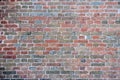Gray red pattern, texture, brick wall with different colored bricks, red, green, gray, brown in summer