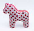 Gray and red textile toy horse with stars and stripes on white