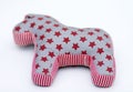 Gray and red textile toy horse with stars and stripes on white