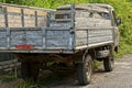 Gray old truck standing in the street on the road Royalty Free Stock Photo