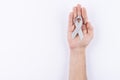 Gray ribbon over palm. White background