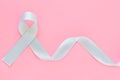 Gray ribbon on pink isolated background copy space. Brain Cancer Awareness, Brain Tumors, Allergies, Asthma, Diabetes Awareness,