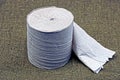 Gray roll of toilet paper on green cloth Royalty Free Stock Photo