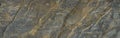 Gray rough mountain surface with yellow-brown veins and cracks. Close-up. Rock texture. Dark rusty stone background with copy spac Royalty Free Stock Photo