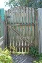 gray rural wooden fence wall and closed old one door Royalty Free Stock Photo