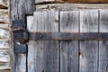 Rusty aged iron hinge on old wooden door Royalty Free Stock Photo