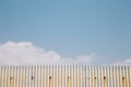 Gray rusty wavy metal plate wall with sky blue