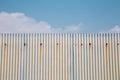 Gray rusty wavy metal plate wall with sky blue