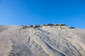 Gray sand dunes and the blue sky Royalty Free Stock Photo