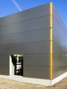 Gray sandwich panels facade of a new metal construction thermally insulated industrial building Royalty Free Stock Photo