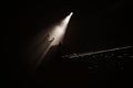 Gray scale shot of a person standing on the stage under the spotlight Royalty Free Stock Photo