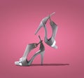 Gray shoes falling vivid pink background