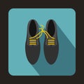 Gray shoes with laces tied together icon