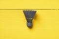 Gray shuttlecock on yellow background top view Royalty Free Stock Photo