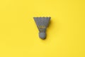 Gray shuttlecock on yellow background top view Royalty Free Stock Photo