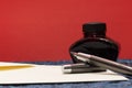 Gray and silver fountain pen, black ink bottle