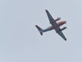 In the gray sky flies the propeller transport plane Royalty Free Stock Photo