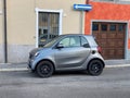 Gray Smart Fortwo car parked in the street.