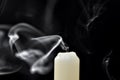 Gray smoke from an extinguished candle develops on a black background Royalty Free Stock Photo