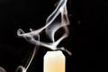 Gray smoke from an extinguished candle develops on a black background Royalty Free Stock Photo