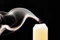 Gray smoke from an extinguished candle develops on a black background Royalty Free Stock Photo