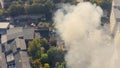 Smoke from a fire in the city: industrial fire, aerial copter view