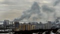 Gray smoke from the pipes metallurgical plant covers city buildings