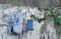 Gray sneakers and a smartphone lie on gray stones. Concept tourism.