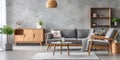 Gray sofa and armchair near wooden coffee table in cozy apartment. Interior design of modern Scandinavian living room Royalty Free Stock Photo