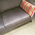 Gray sofa with colorful striped cushion Royalty Free Stock Photo