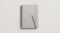 Gray Spiral Notebook with Pencil on White Background Royalty Free Stock Photo