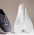 Gray sport shoes  with orthopedic insoles. Foot care products conception Royalty Free Stock Photo