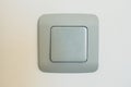 Gray square switch on a rounded wall, close-up Royalty Free Stock Photo