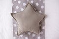 Gray star cushion mock up on a grey and white background with stars