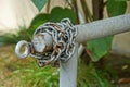 Gray steel chain on the barrier pipe on the fence Royalty Free Stock Photo